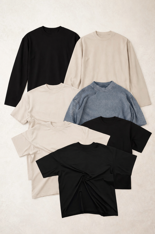 Heavyweight blank t-shirts in black, ecru and stone wash charcoal laid flat, illustrating cost per unit and bulk pricing options for UK clothing brands buying wholesale blanks