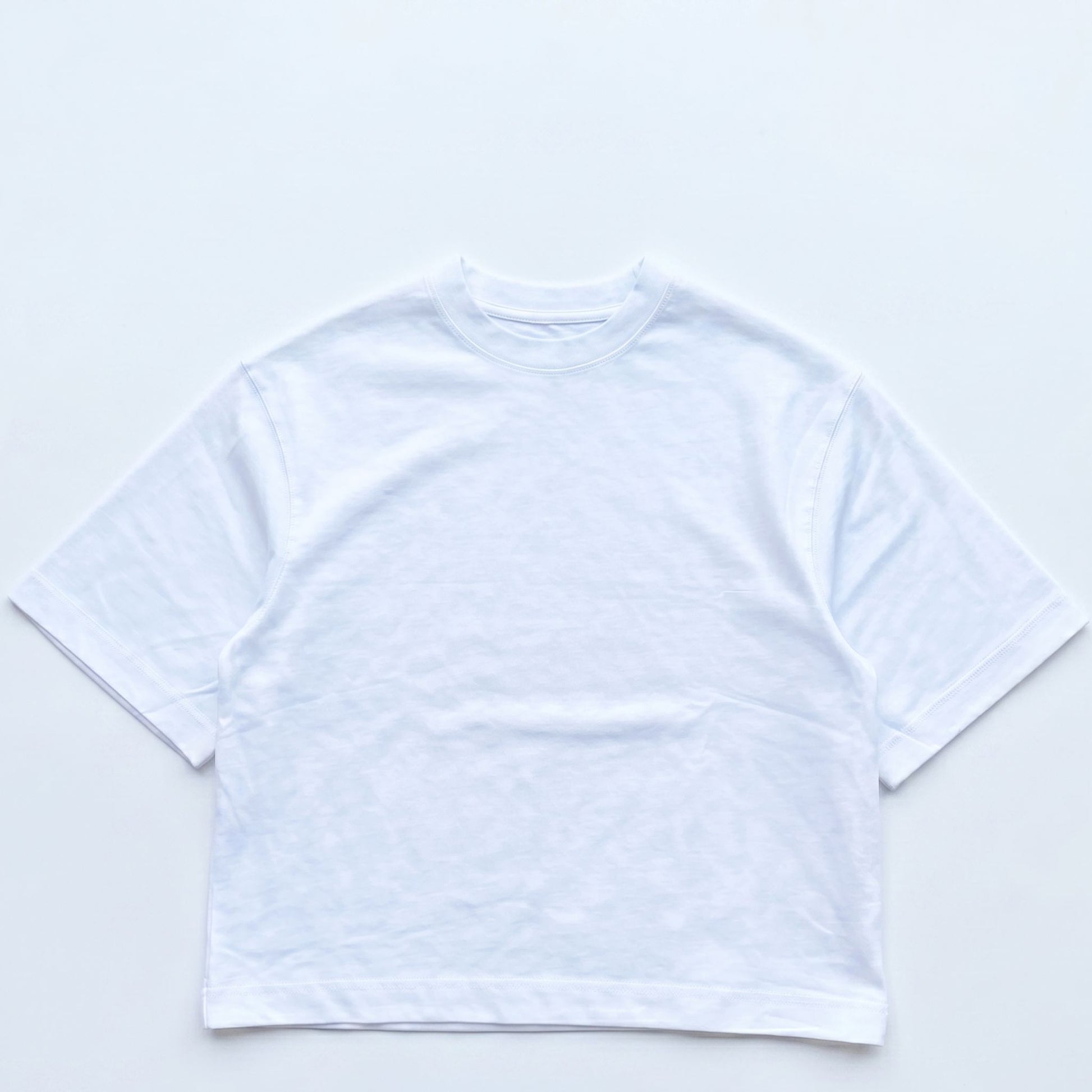 White crop top on a light gray background