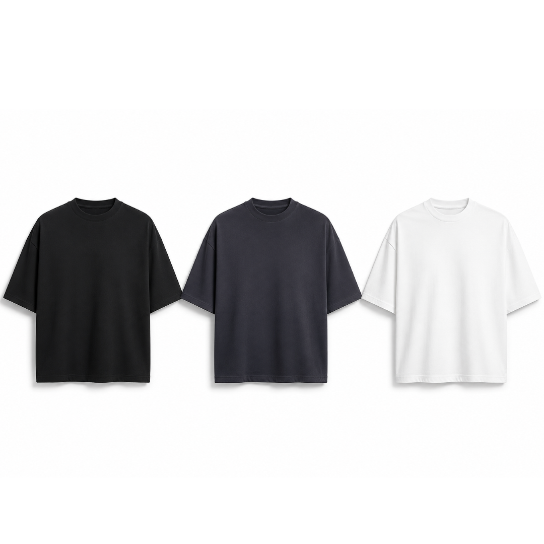Three plain t-shirts in black, gray, and white on a white background