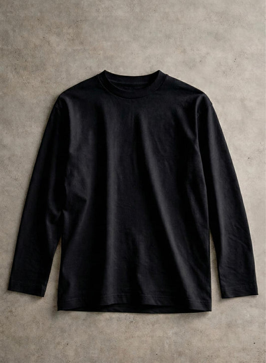 Black long-sleeve shirt on a textured beige background